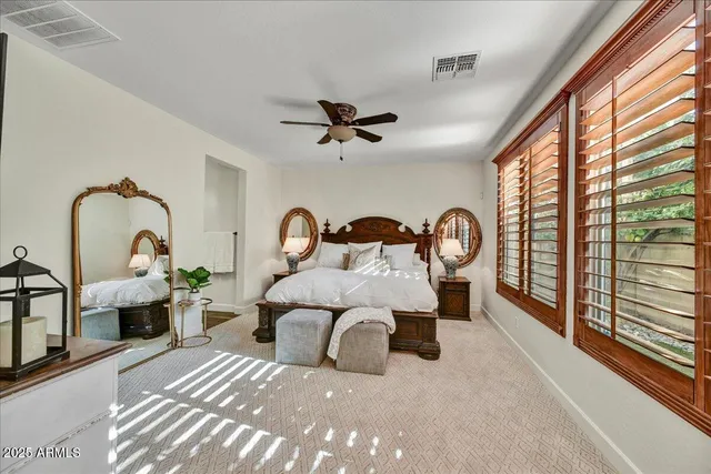 a bedroom with bed and a large window