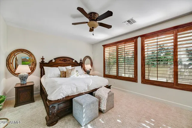 a bedroom with furniture and a large window