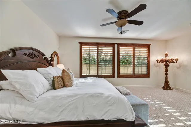 a bedroom with a bed and ceiling fan