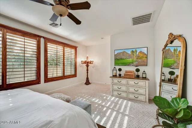 a bedroom with furniture and a flat screen tv