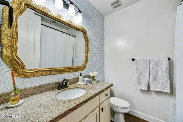 a bedroom with a bed and a dresser in it