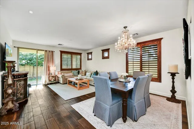 a living room with fireplace furniture and a large window