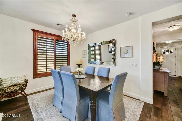 a view of a dining room with furniture and chandelier