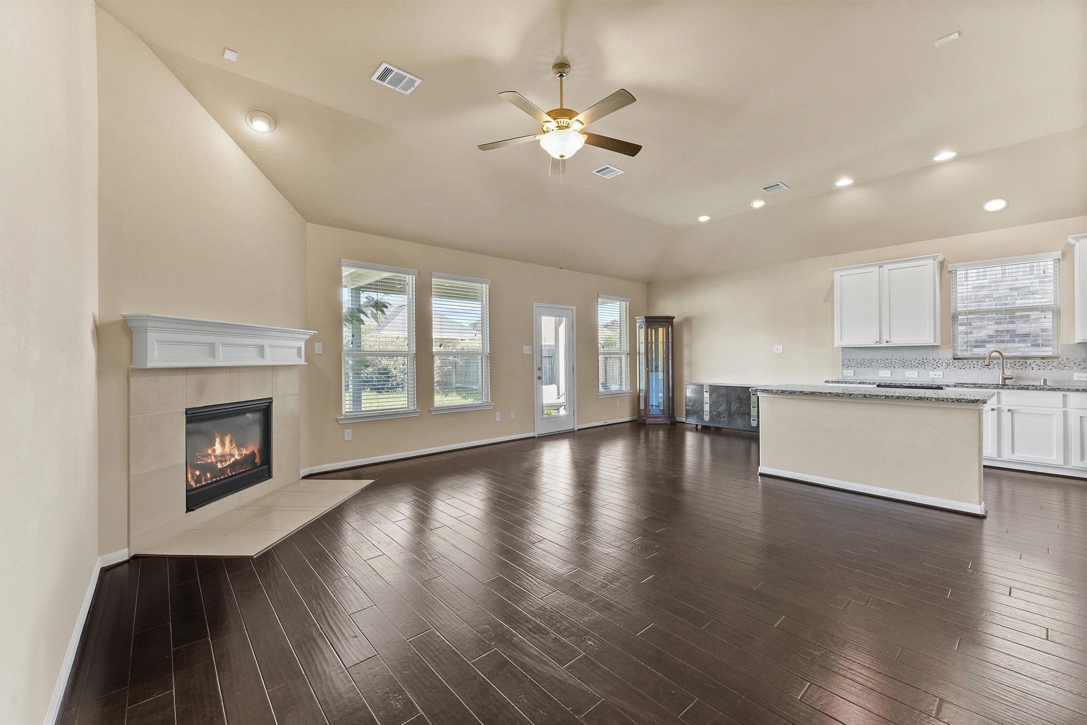 3841 Enchanted Timbers Lane Spring, TX 77386 - Photo 6 of 28 a view of an empty room with wooden floor and a kitchen