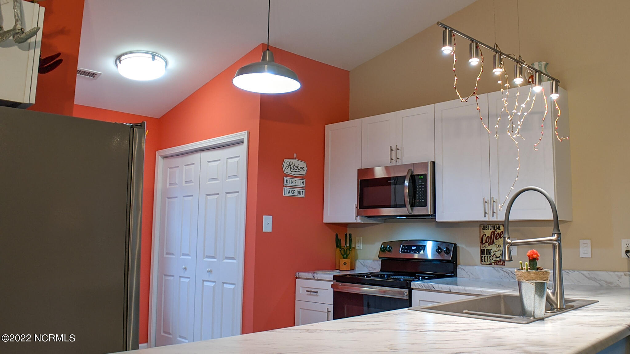 601 Peletier Loop Road, Unit B7 Swansboro, NC 28584 - Photo 3 of 19 Washer and dryer is located in the kitchen behind double closet doors Kitchen has tiled flooring