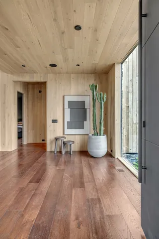 a large kitchen with kitchen island a large window a sink and stainless steel appliances