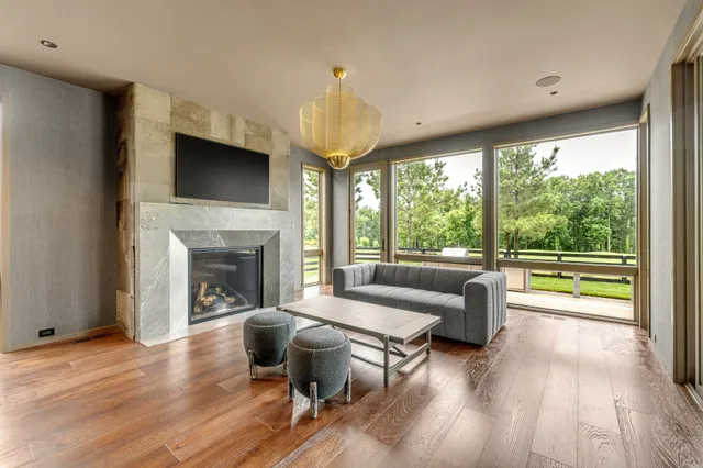 a spacious bedroom with a bed and a flat screen tv