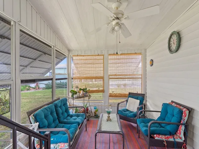 a living room with furniture and a floor to ceiling window