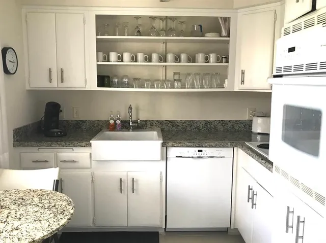 a kitchen with stainless steel appliances granite countertop a sink and cabinets