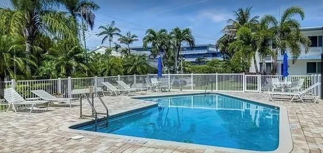 a view of a swimming pool with a lounge chair
