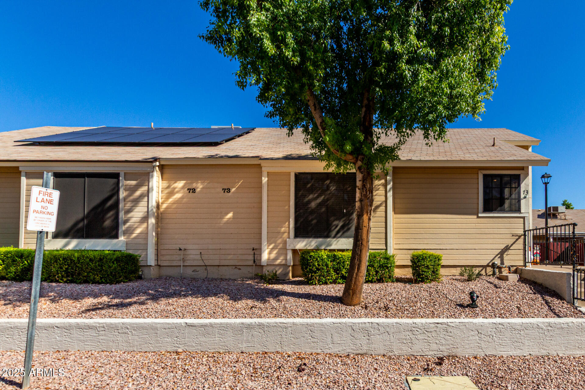 2455 East Broadway Road, Unit 73 Mesa, AZ 85204 - Photo 1 of 35 a front view of a house with garden