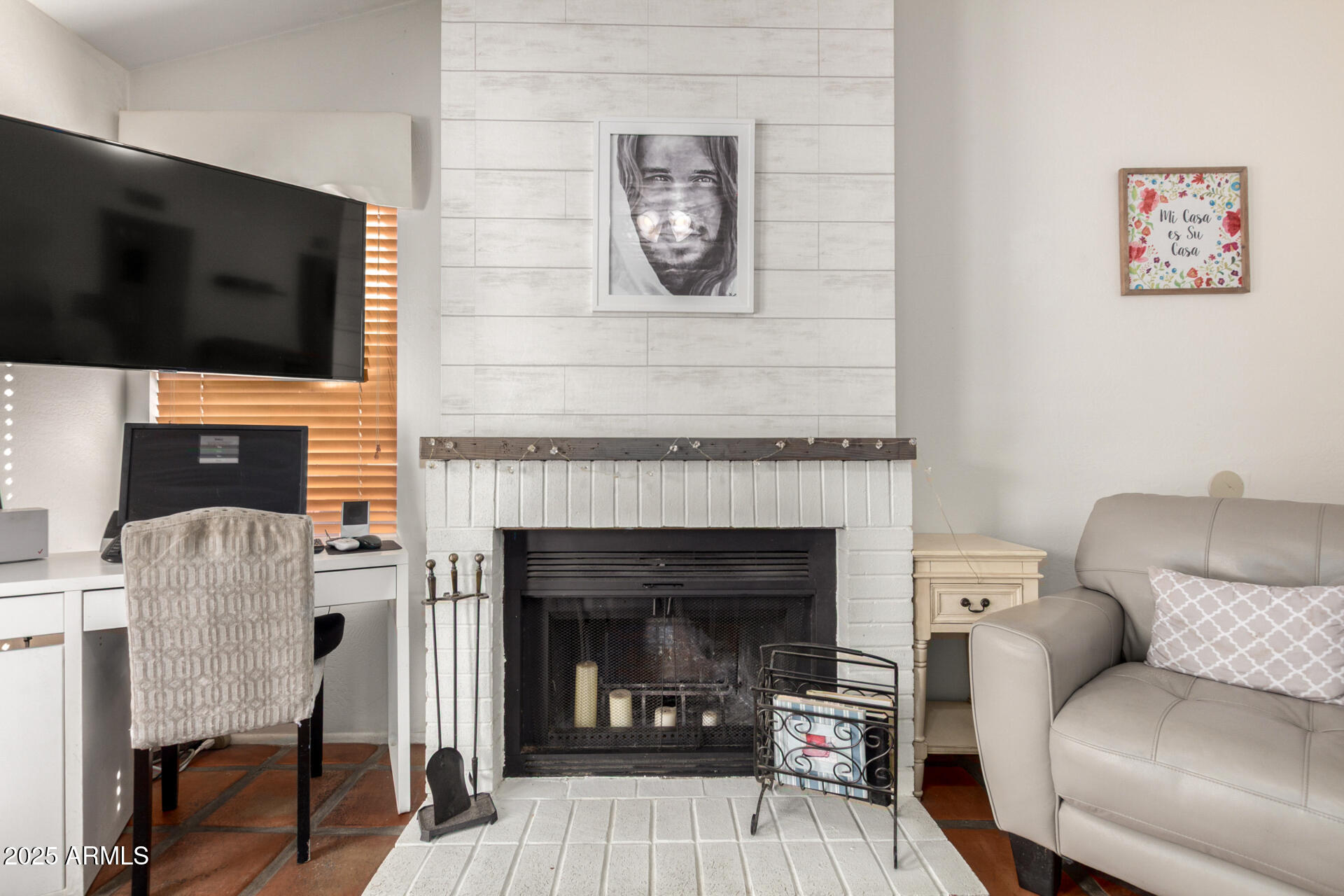 2455 East Broadway Road, Unit 73 Mesa, AZ 85204 - Photo 11 of 35 a living room with furniture a flat screen tv and a fireplace
