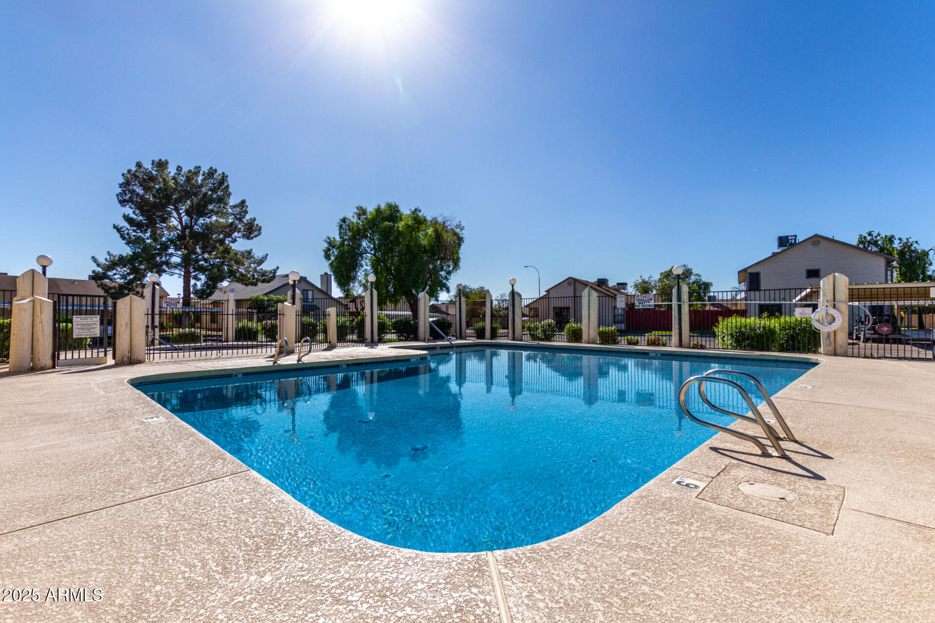 2455 East Broadway Road, Unit 73 Mesa, AZ 85204 - Photo 30 of 35 a view of a swimming pool with a lounge chairs