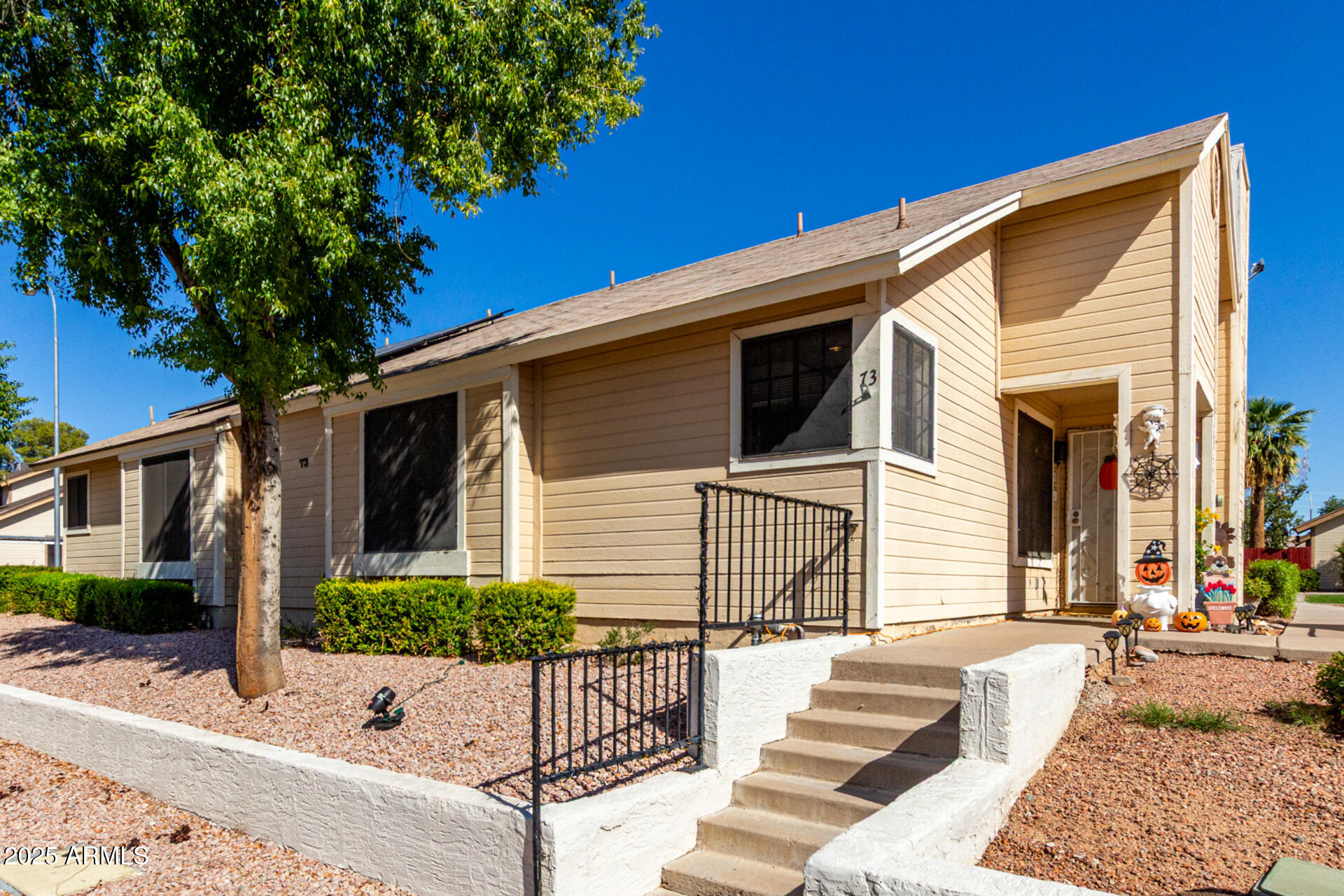 2455 East Broadway Road, Unit 73 Mesa, AZ 85204 - Photo 3 of 35 a view of a house with a small yard