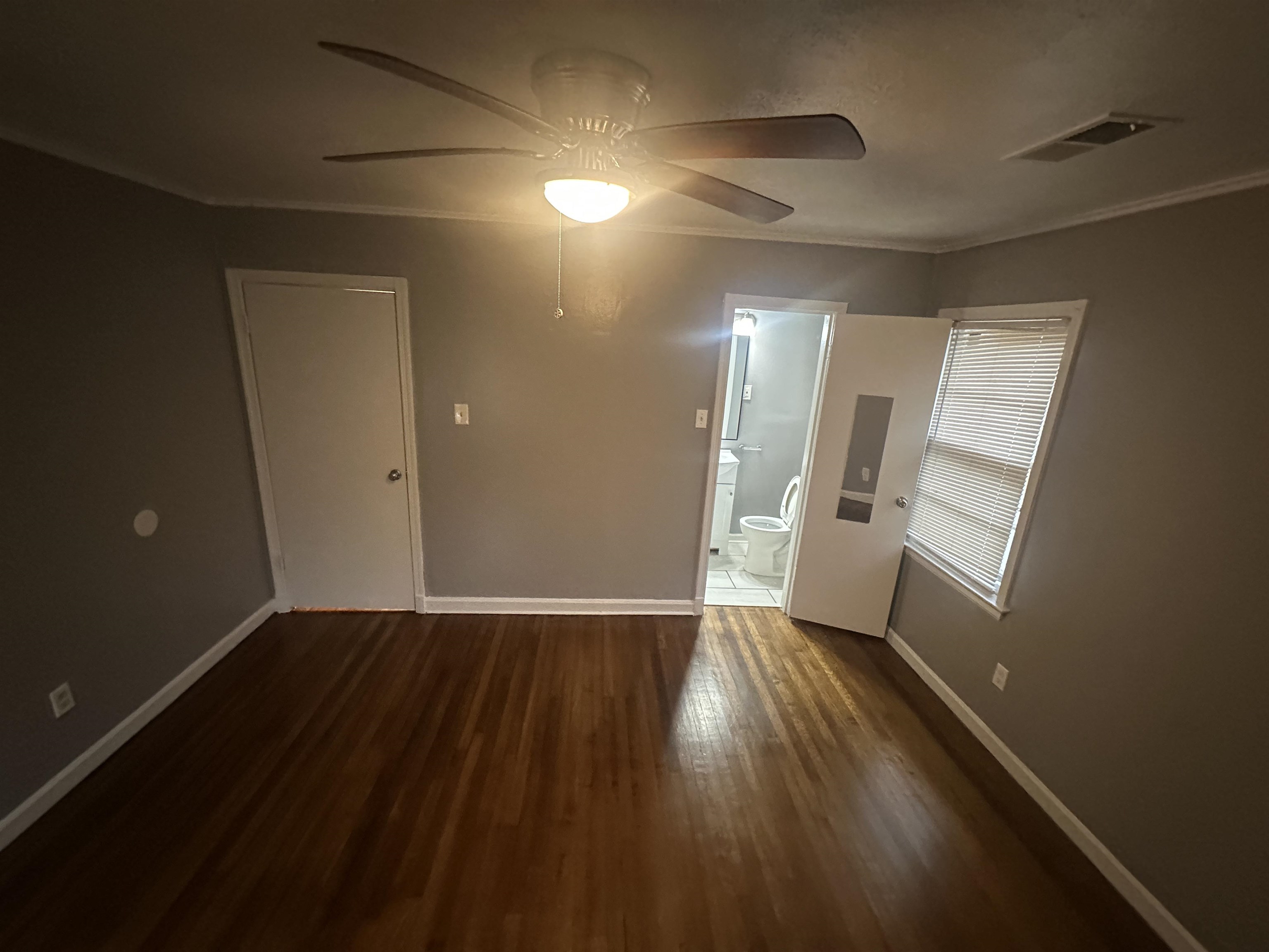 1285 Old Hickory Road Memphis, TN 38116 - Photo 13 of 31 Spare room with baseboards, crown molding, visible vents, and dark wood-type flooring