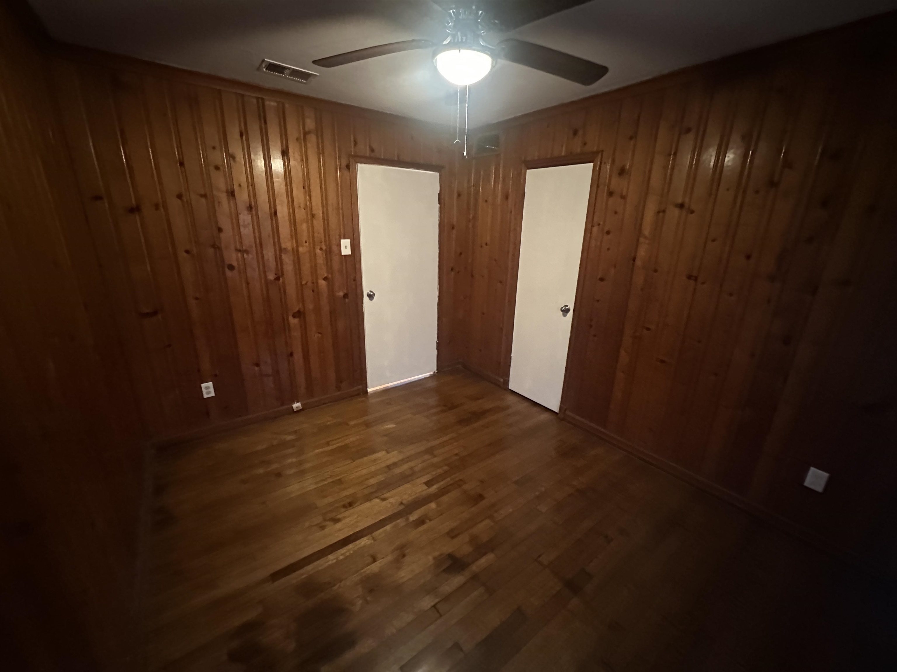 1285 Old Hickory Road Memphis, TN 38116 - Photo 16 of 31 Interior space with dark wood-style floors, ceiling fan, wood walls, and visible vents