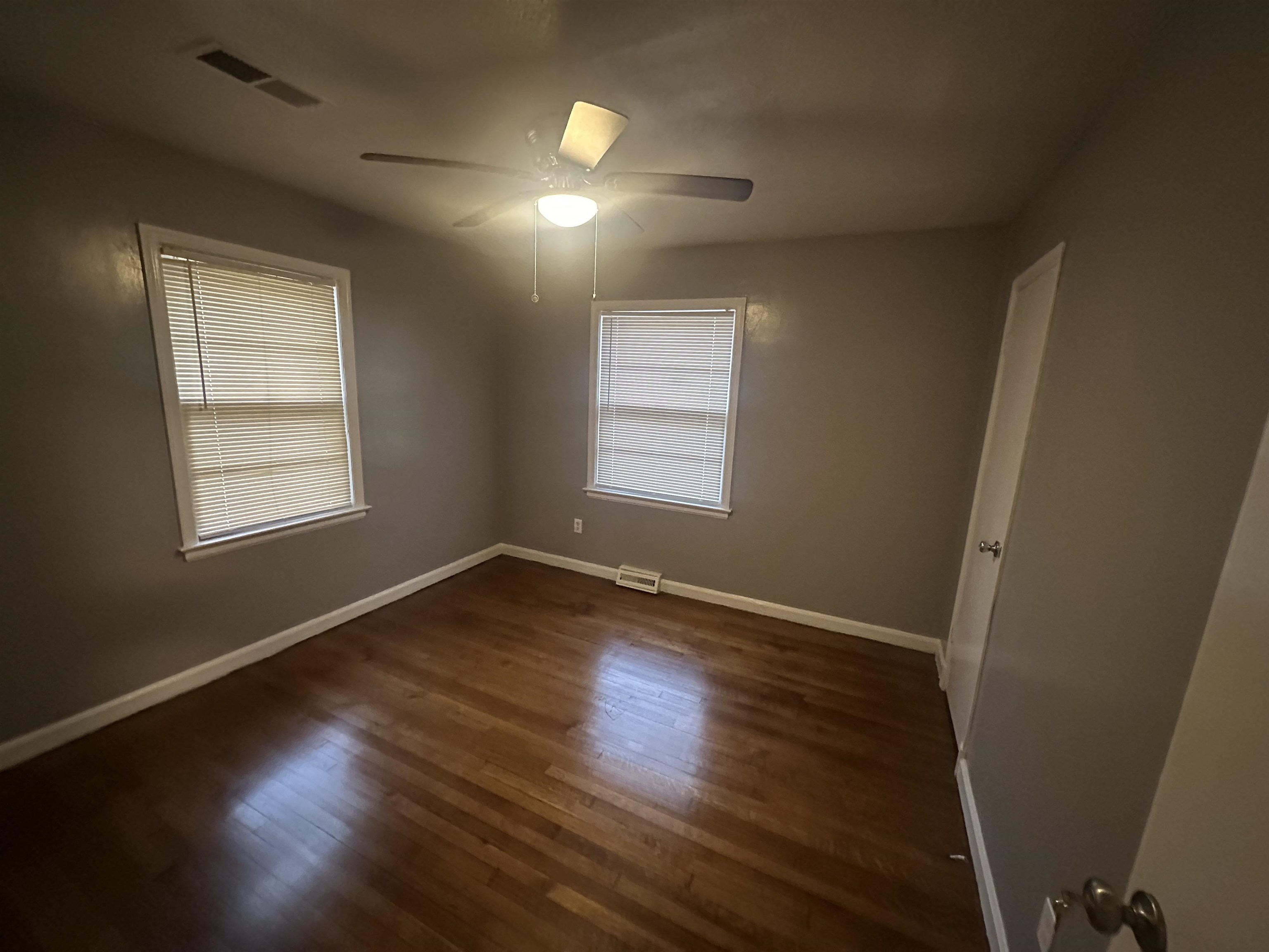 1285 Old Hickory Road Memphis, TN 38116 - Photo 17 of 31 Empty room with a ceiling fan, dark wood-style flooring, visible vents, and baseboards