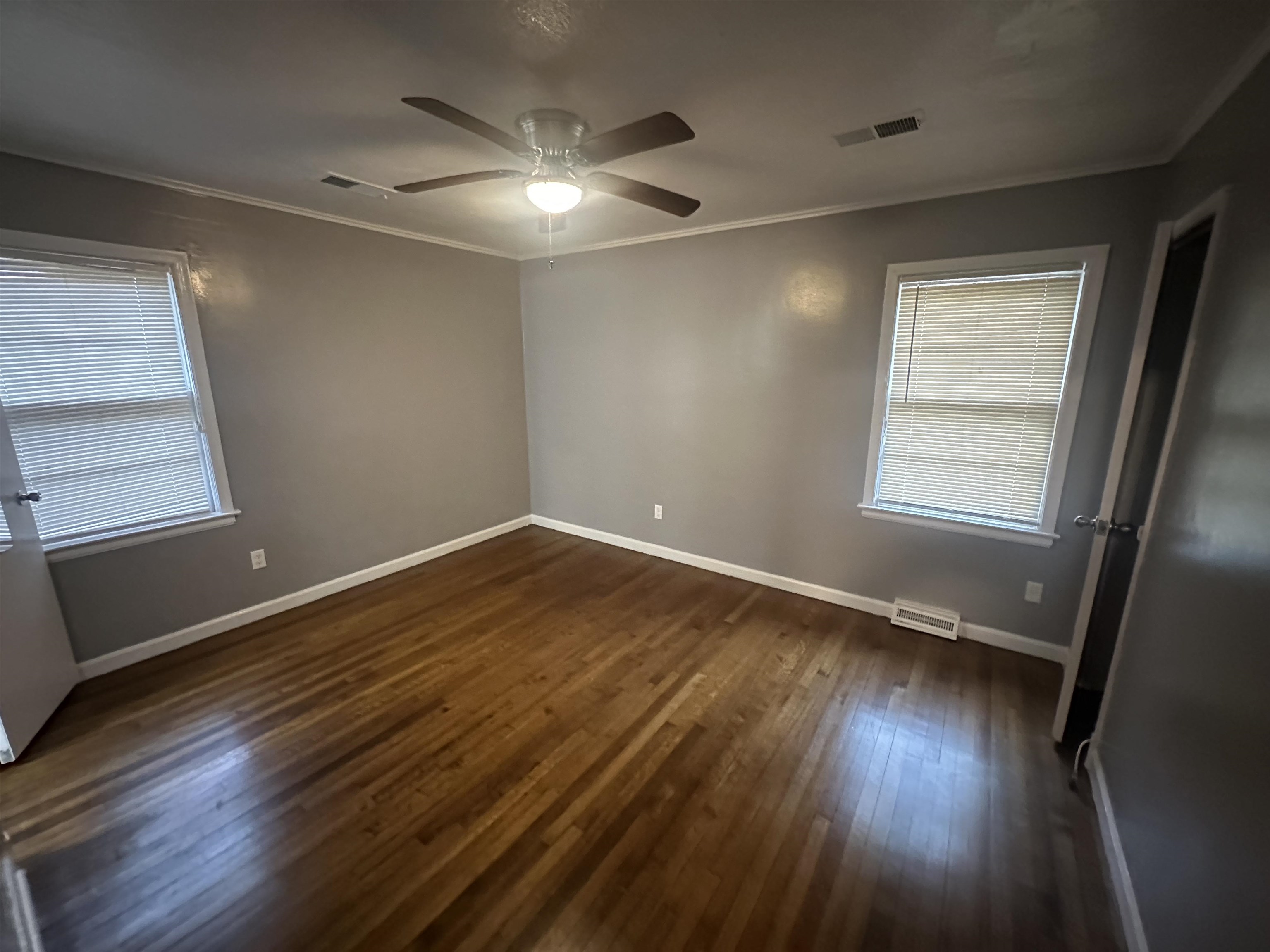 1285 Old Hickory Road Memphis, TN 38116 - Photo 19 of 31 Spare room with ornamental molding, visible vents, and dark wood-style floors