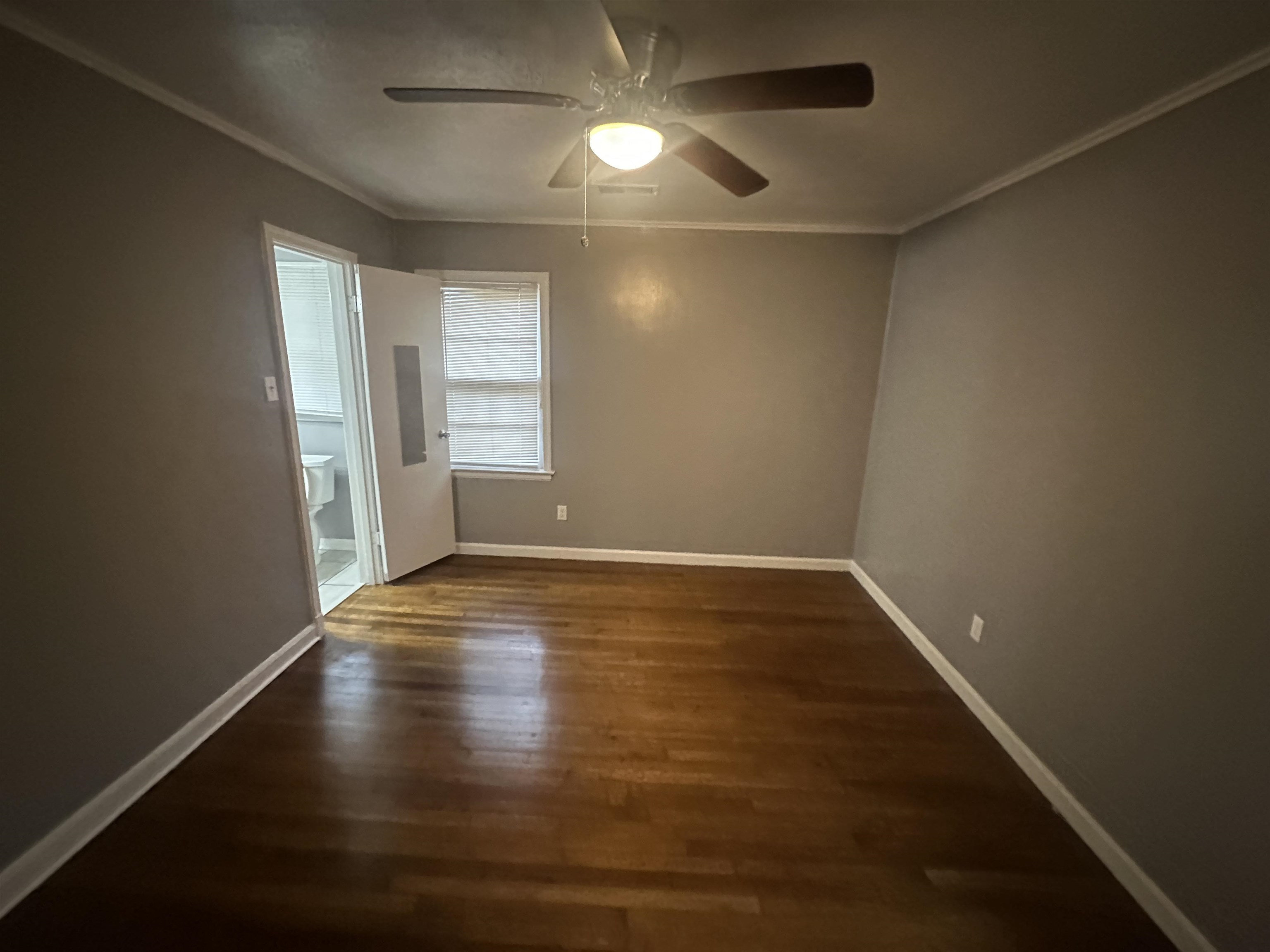 1285 Old Hickory Road Memphis, TN 38116 - Photo 20 of 31 Spare room with dark wood-type flooring, ornamental molding, baseboards, and a ceiling fan