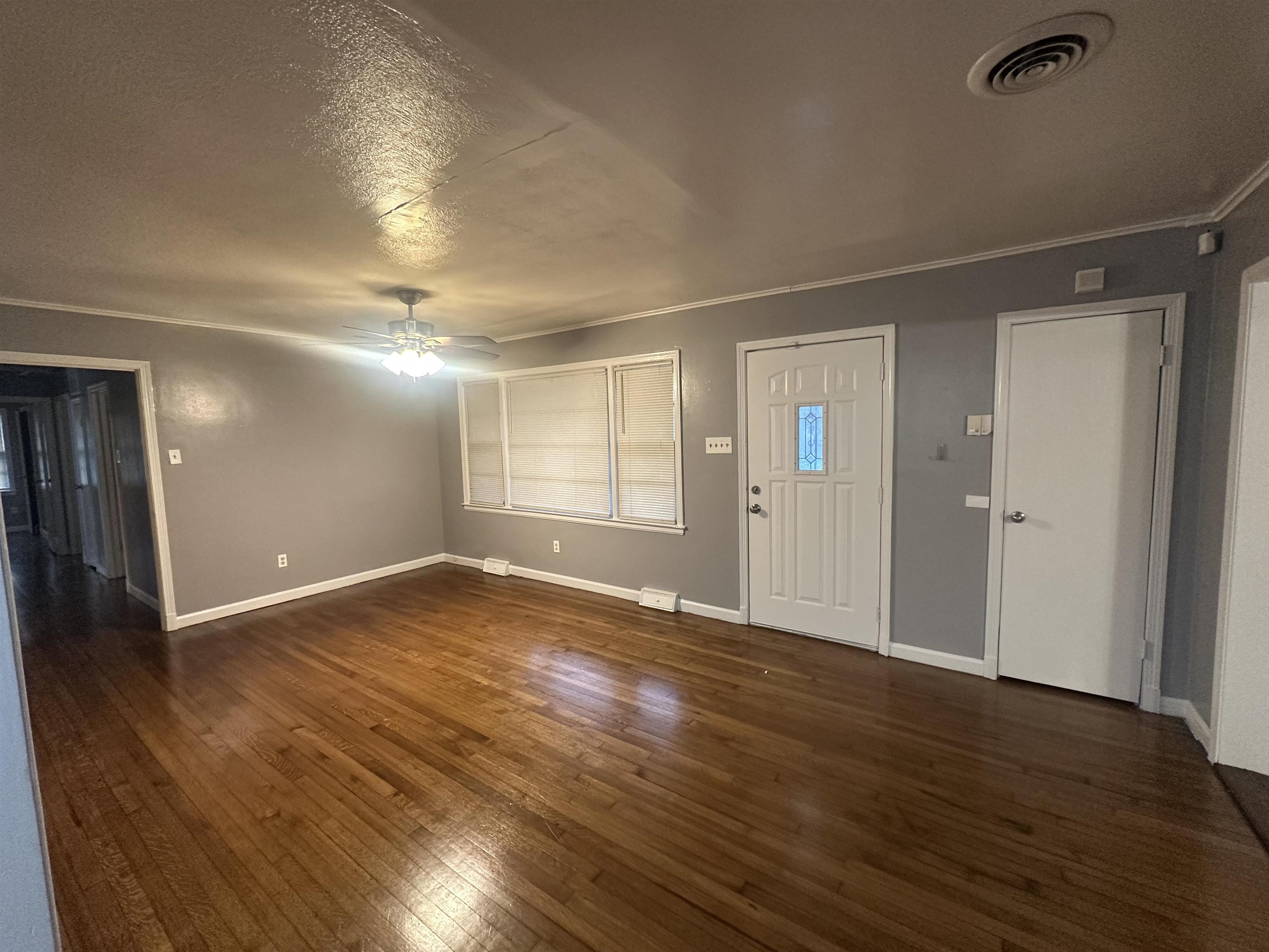 1285 Old Hickory Road Memphis, TN 38116 - Photo 2 of 31 Entrance foyer featuring dark wood-type flooring, visible vents, baseboards, a ceiling fan, and ornamental molding