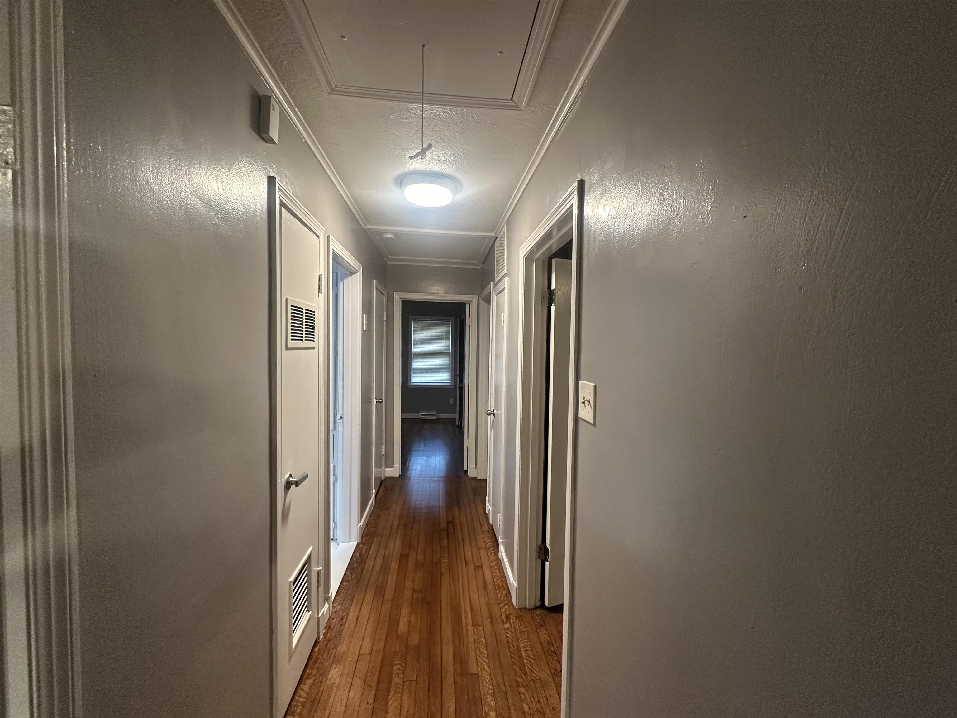 1285 Old Hickory Road Memphis, TN 38116 - Photo 23 of 31 Hall featuring a textured ceiling, ornamental molding, dark wood-type flooring, and attic access