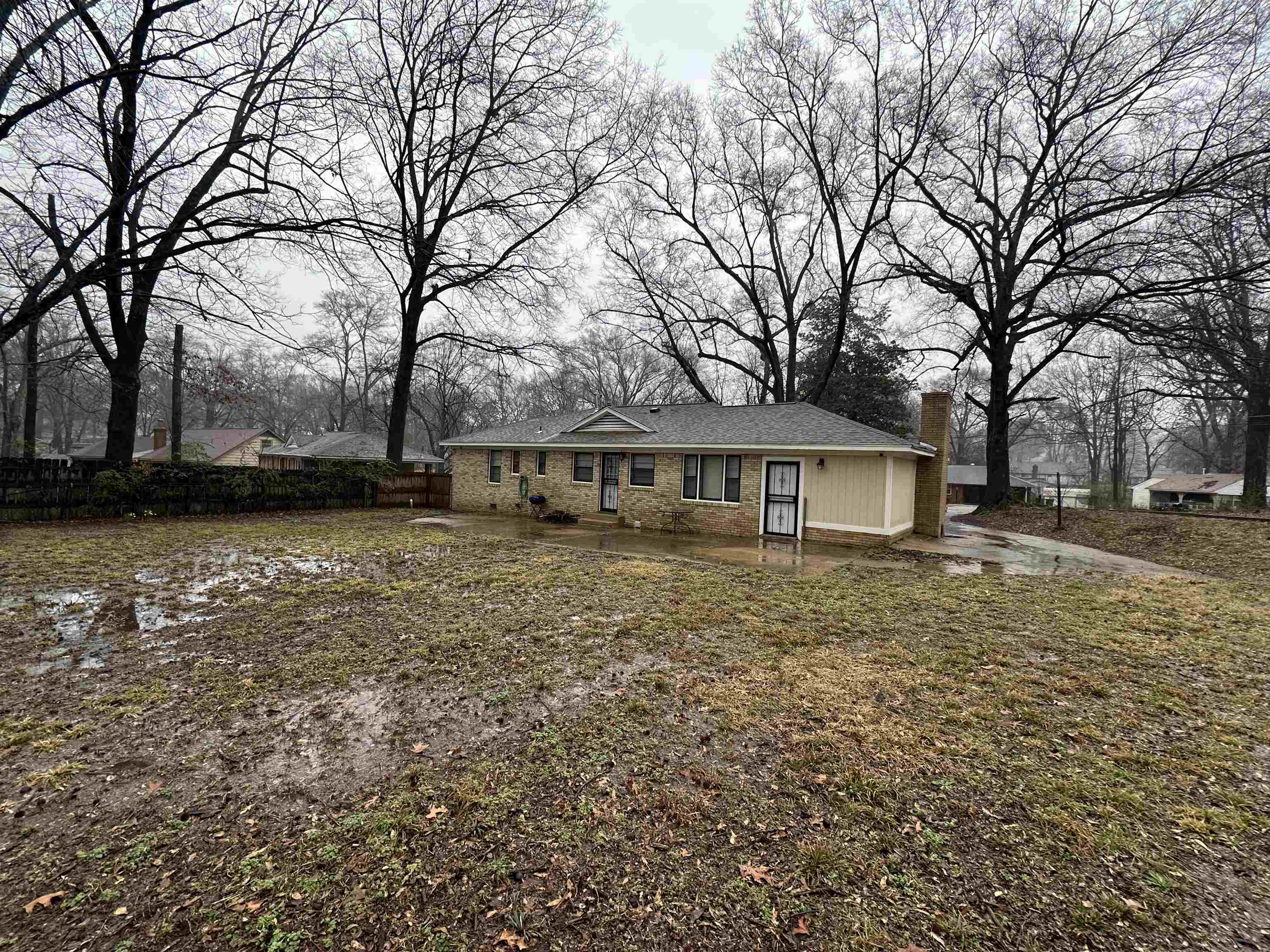 1285 Old Hickory Road Memphis, TN 38116 - Photo 25 of 31 View of front of home featuring brick siding, a chimney, a front yard, and fence