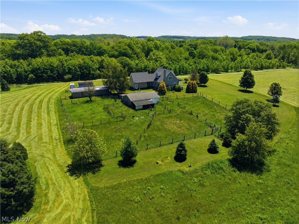 12159 Lawndell Road Southwest Beach City, OH 44608 - Photo 45 of 49 Expansive rural property featuring a main residence with a gray siding exterior and dark shingle roof, accompanied by multiple outbuildings