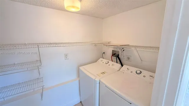 a kitchen that has a sink a stove and a refrigerator