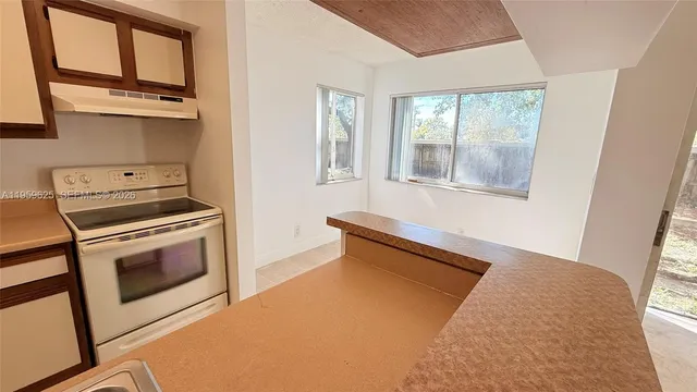 a kitchen with stainless steel appliances granite countertop a stove and a microwave