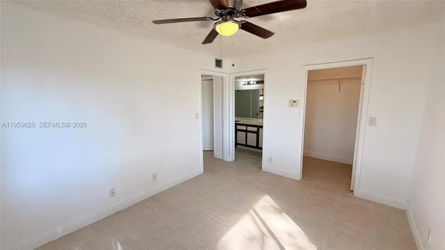 a white bath tub sitting next to a white sink and vanity