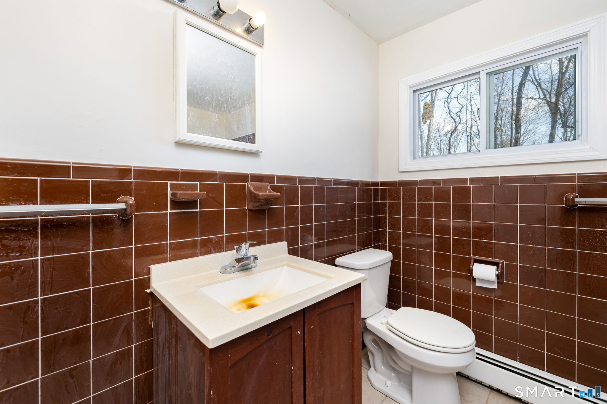461 Pond Road Franklin, CT 06254 - Photo 21 of 35 a bathroom with a sink toilet and window
