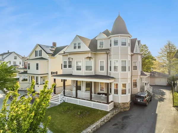 a view of a large white building with a tub and large windows