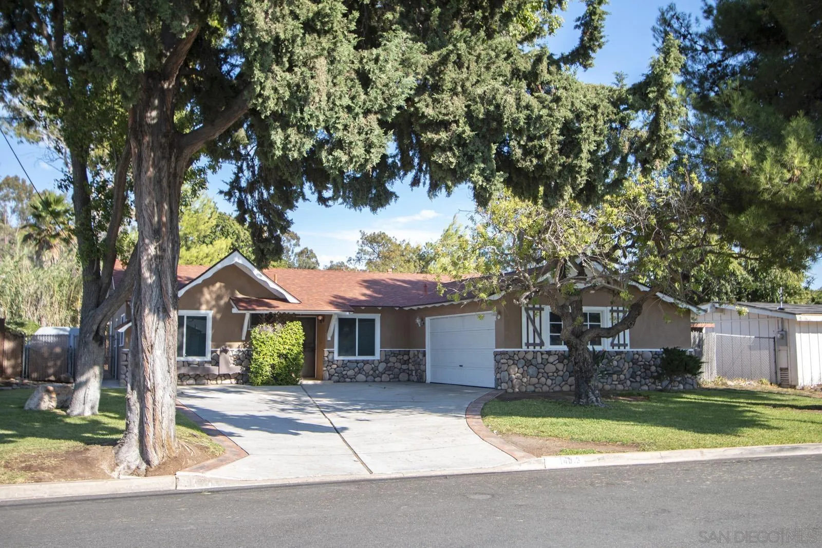 14013 Powers Road Poway, CA 92064 - Photo 1 of 1 a front view of a house with a garden and tree