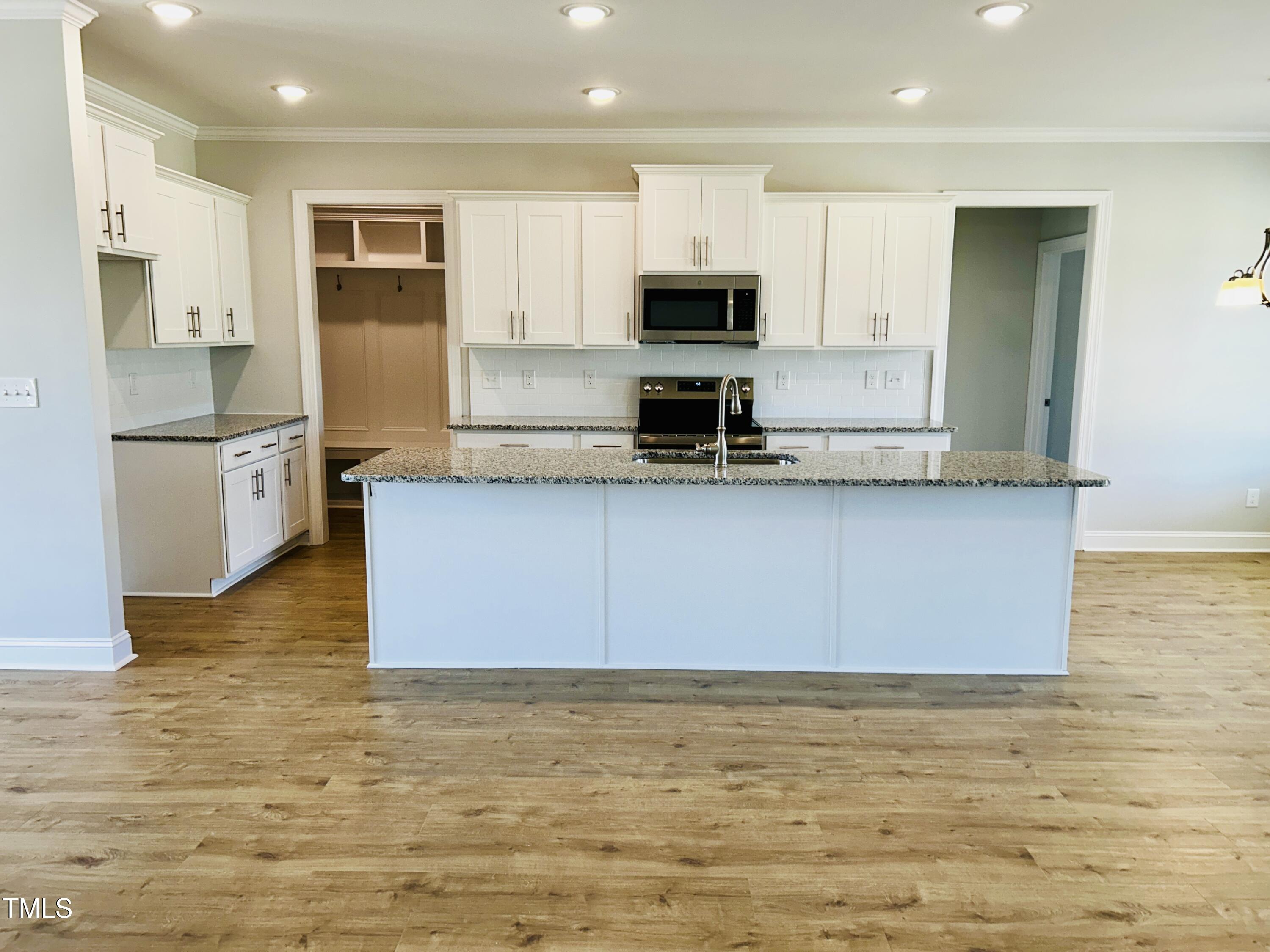 3912 Origin Drive Bailey, NC 27807 - Photo 6 of 20 a kitchen with stainless steel appliances granite countertop a stove a sink and a refrigerator