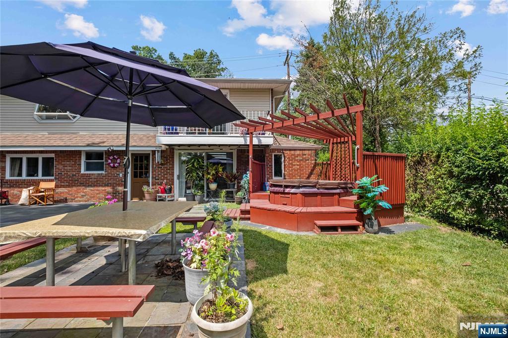 1468 Alps Road Wayne, NJ 07470 - Photo 22 of 36 a view of a patio with table and chairs under an umbrella