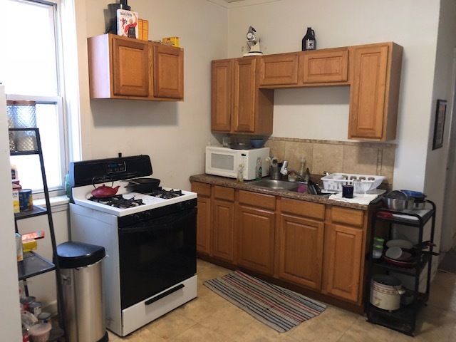 3059 West Lyndale Street Chicago, IL 60647 - Photo 4 of 10 a kitchen with stainless steel appliances granite countertop a stove and a sink