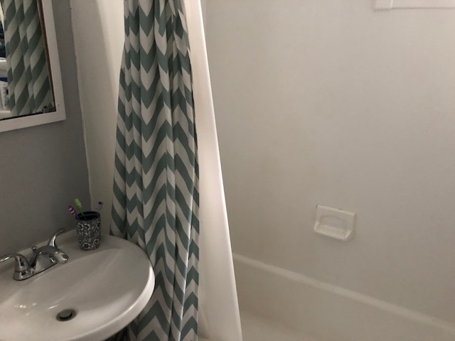 3059 West Lyndale Street Chicago, IL 60647 - Photo 10 of 10 a bathroom with a sink and a mirror