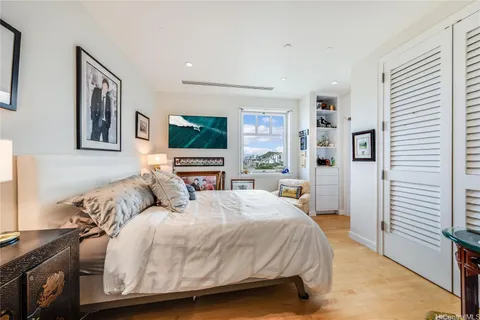 a living room with a bed furniture and a flat screen tv