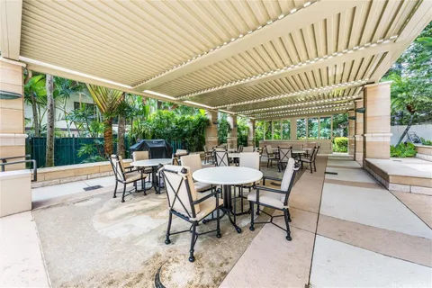 a balcony with furniture and a potted plant