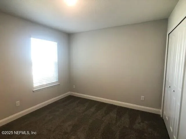 a view of an empty room and wooden floor
