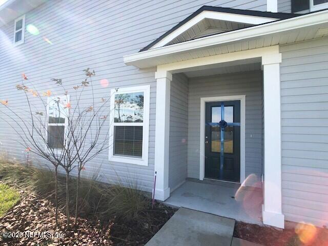 13991 Molina Drive Jacksonville, FL 32256 - Photo 2 of 34 a view of a porch with a yard