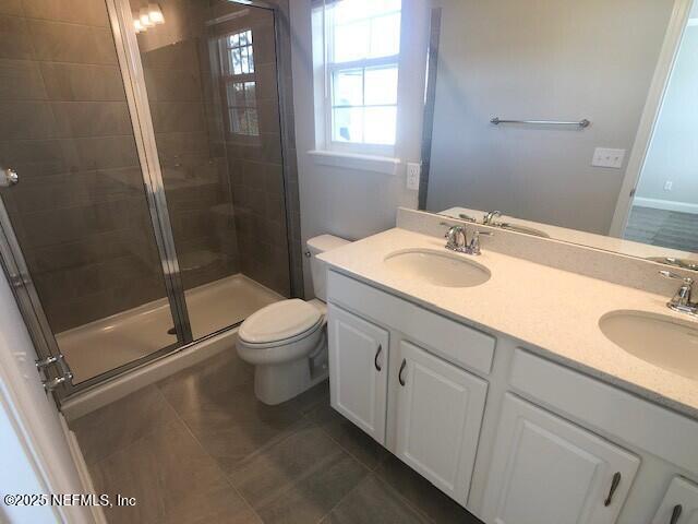 13991 Molina Drive Jacksonville, FL 32256 - Photo 22 of 34 a bathroom with a granite countertop toilet a sink and a mirror