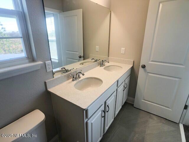 13991 Molina Drive Jacksonville, FL 32256 - Photo 23 of 34 a bathroom with a sink and a toilet
