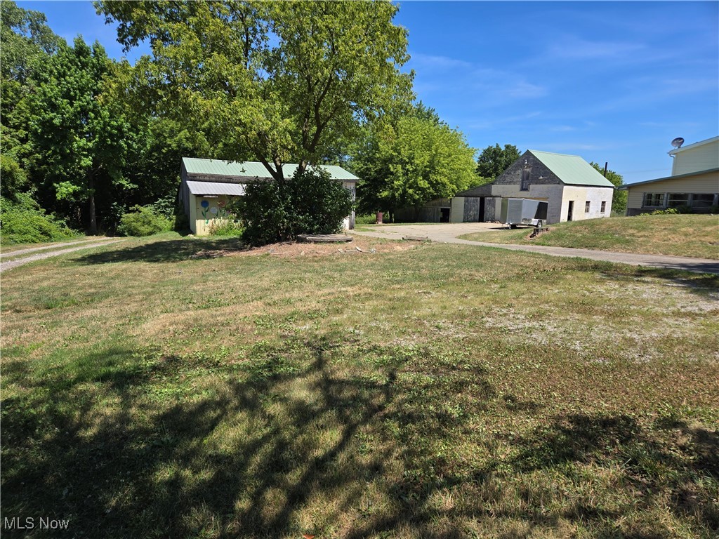5555 Detroit Road Sheffield, OH 44054 - Photo 36 of 50 View of green lawn with an outdoor structure