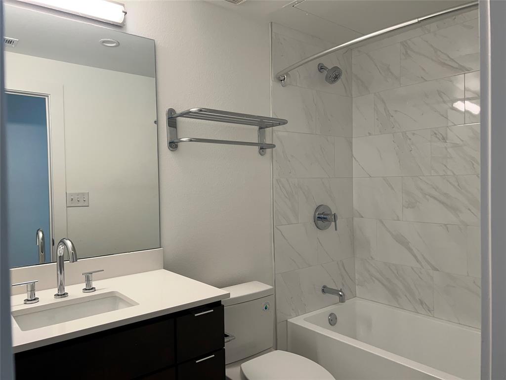 408 Martin Luther King Junior Boulevard, Unit 401 Waxahachie, TX 75165 - Photo 11 of 15 a bathroom with a sink a toilet and shower