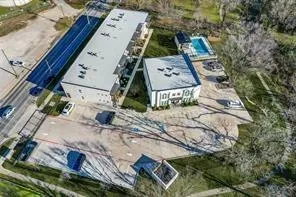 a view of a building with a fountain in a yard