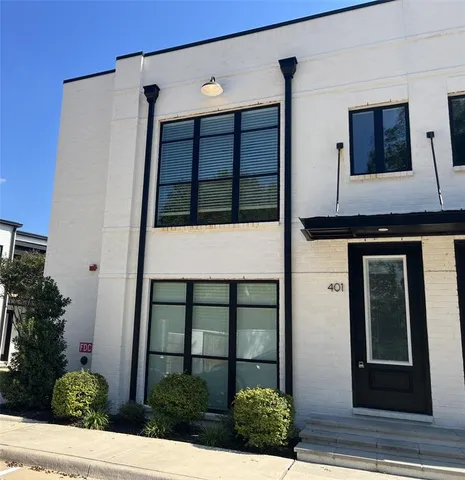 an entryway with wooden floor and cabinet