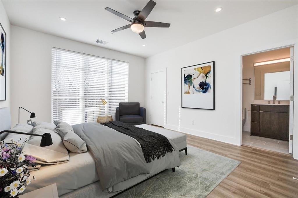 408 Martin Luther King Junior Boulevard, Unit 401 Waxahachie, TX 75165 - Photo 4 of 15 a bedroom with a bed and a chandelier