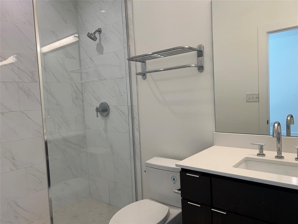 408 Martin Luther King Junior Boulevard, Unit 401 Waxahachie, TX 75165 - Photo 6 of 15 a bathroom with a sink toilet and shower