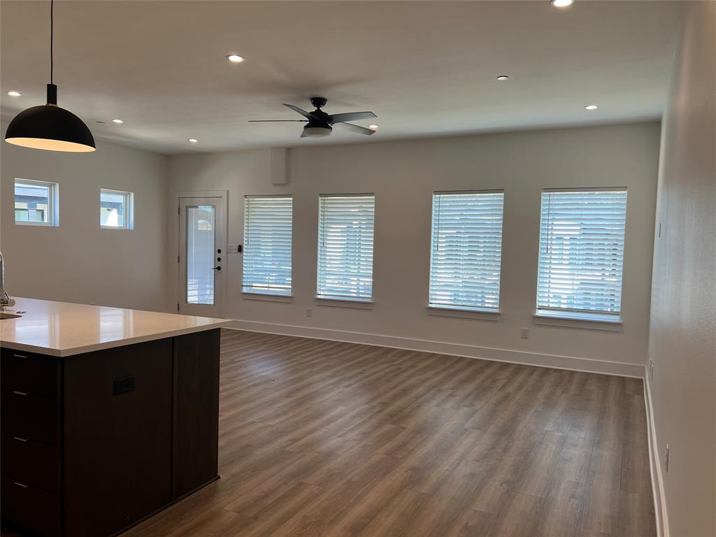 408 Martin Luther King Junior Boulevard, Unit 401 Waxahachie, TX 75165 - Photo 7 of 15 a view of a room with wooden floor and windows